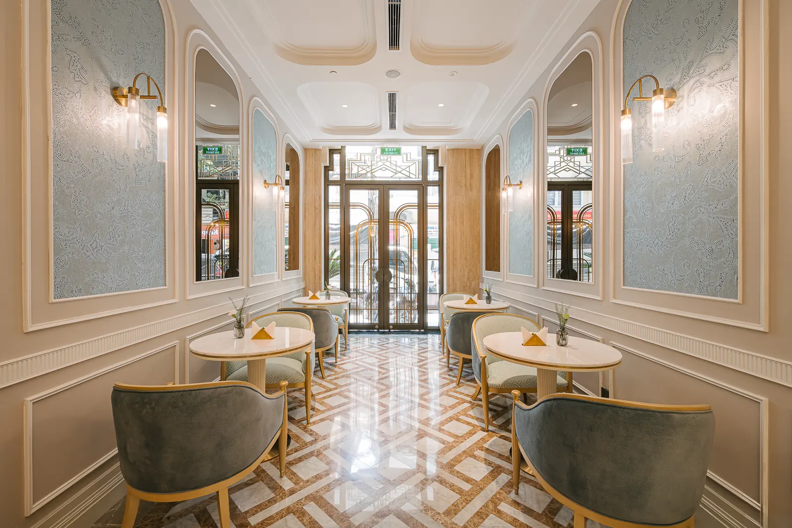 Entrance with a geometric floor, mirrors and empty tables — Crema Pastry · Classyc Hàng Buồm