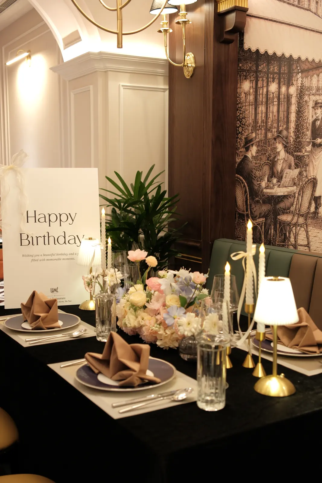 Birthday table with pastel flowers and taper candles — Lumé Restaurant · Classyc Hàng Buồm
