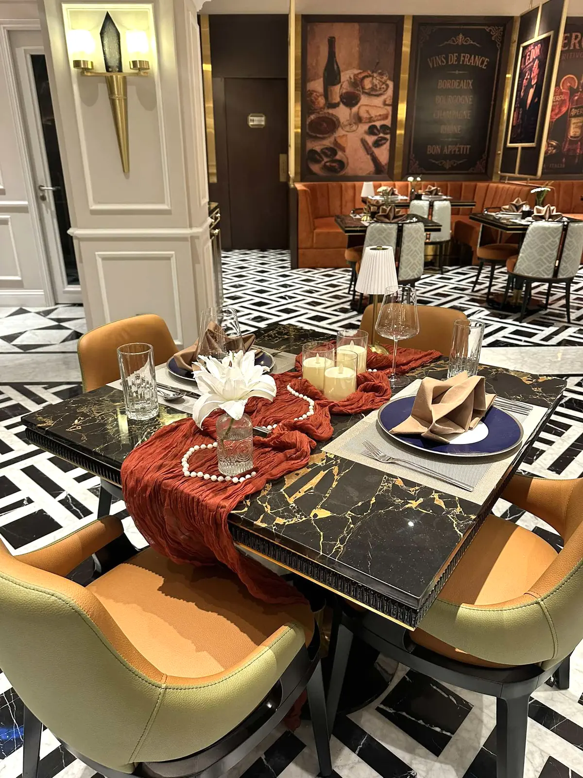 Table with a white lily, pearls and pillar candles — Lumé Restaurant · Classyc Hàng Buồm