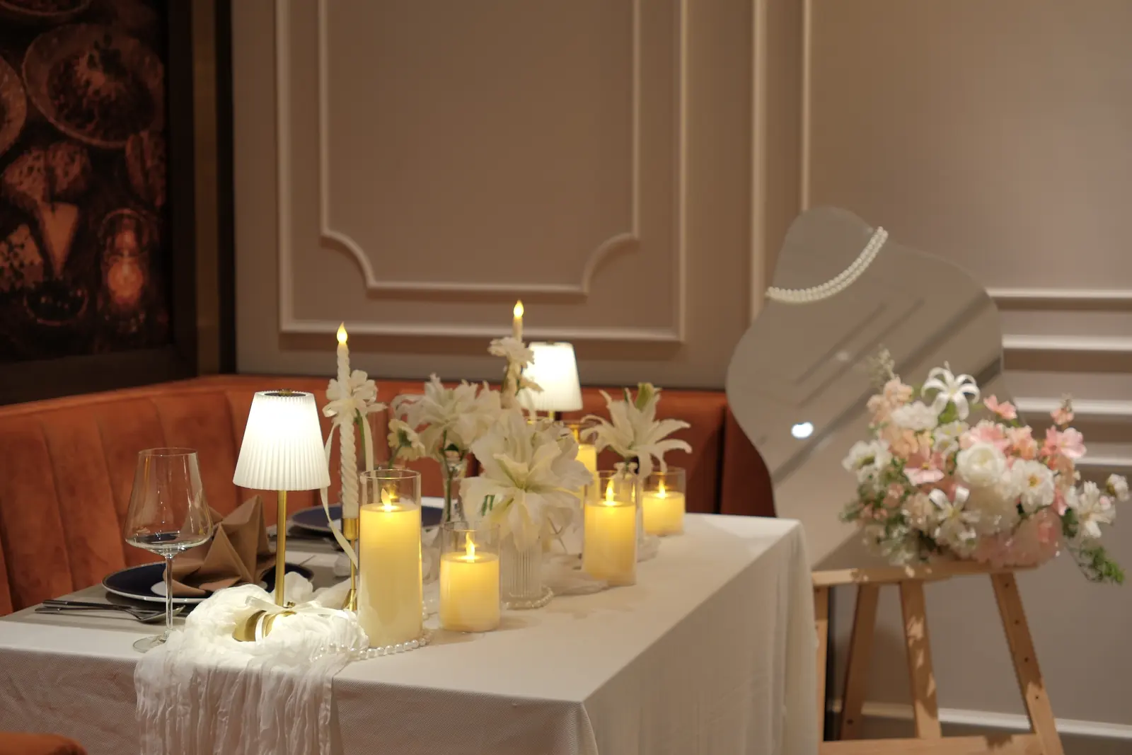 Table with lilies, candles and flowers on an easel — Lumé Restaurant · Classyc Hàng Buồm