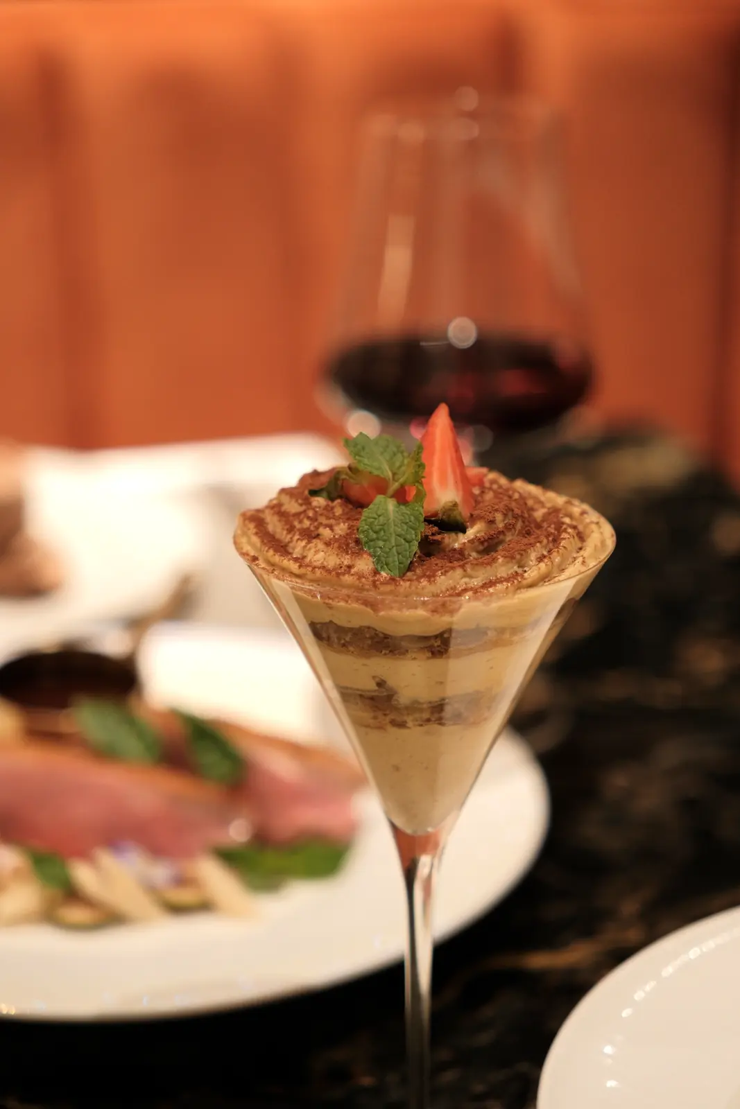 Layered cocoa dessert in a martini glass with a strawberry — Lumé Restaurant · Classyc Hàng Buồm
