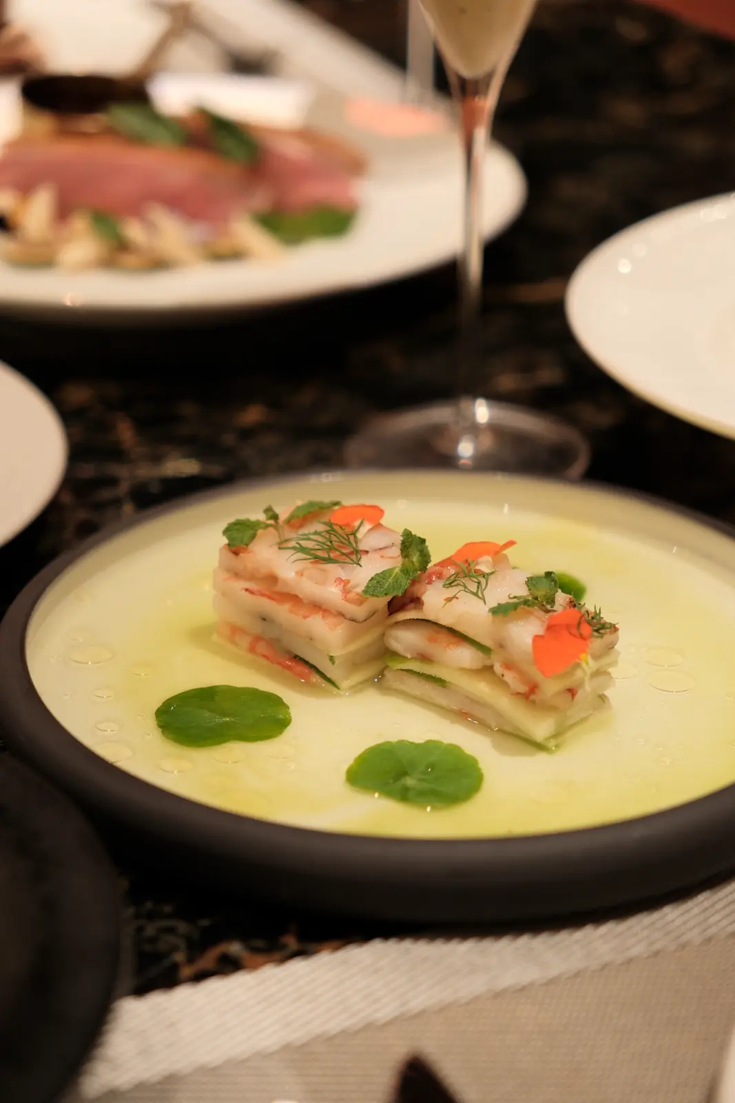 Stacked pale layers in a light green sauce — Lumé Restaurant · Classyc Hàng Buồm