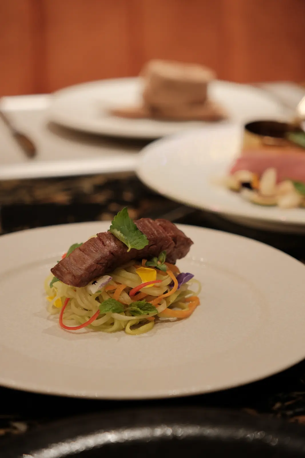 Seared meat with shredded vegetables and flowers — Lumé Restaurant · Classyc Hàng Buồm